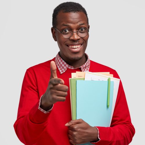 horizontal-shot-handsome-smiling-young-man-makes-gun-gesture-dressed-red-casual-jumper-being-good-mood (1)